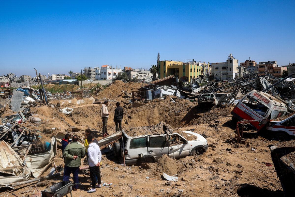 Palestinians inspect damage at an ambulance repair yard hit in Israeli strikes in the al-Maghazi refugee camp in the central Gaza Strip on March 24, 2025. (Eyad Baba/AFP via Getty Images)