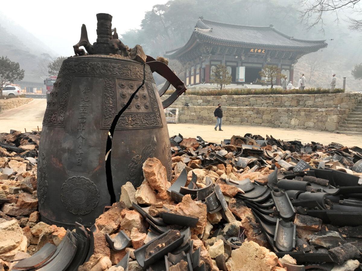 A bell is seen broken at the remains of the bell pavilion at Goun Temple in Uiseong, South Korea, on March 26, 2025. (Kim Do-hoon/Yonhap via AP)