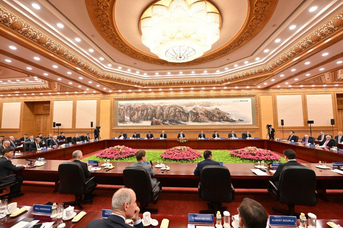 China's leader Xi Jinping (C) speaks during a meeting with a group of foreign executives at the Great Hall of the People in Beijing on March 28, 2025. (Adek Berry/AFP via Getty Images)