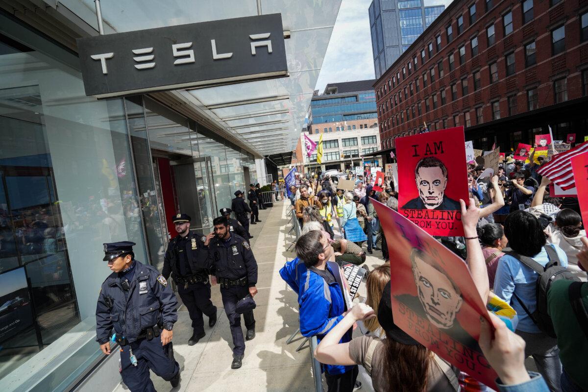 People take part in a protest against Tesla in New York City, on March 29, 2025. (Samira Bouaou/The Epoch Times)
