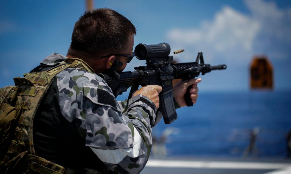 Former navy diver and now-People First Party political candidate John Armfield firing his weapon during his time in service. (Courtesy of John Armfield)