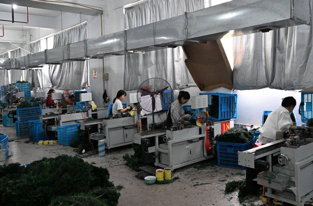 People work at a Christmas tree factory for export and domestic markets in Jinhua, eastern Zhejiang Province, China, on April 11, 2025. (Adek Berry/AFP via Getty Images)