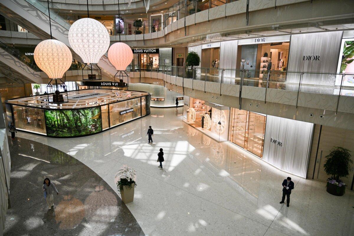 People walk past luxury brand stores at a mall in the financial district of Shanghai, China, on April 14, 2025. (Hector Retamal/AFP via Getty Images)