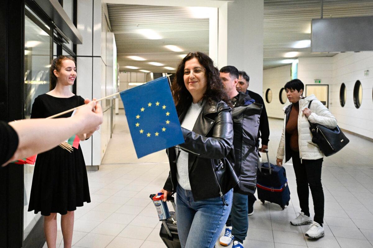 Passengers arriving from Berlin receive European Union flag at Sofia International Airport in Sofia, Bulgaria on March 31, 2024. (Nikolay Doychinov/AFP via Getty Images)