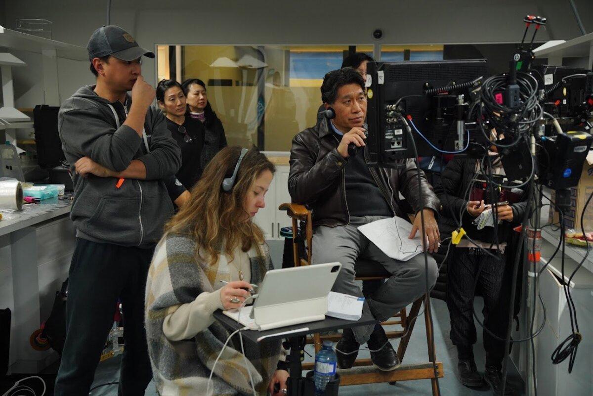 Toronto filmmaker Kevin Yang (R) with the production team on the set of “The Puppeteers.