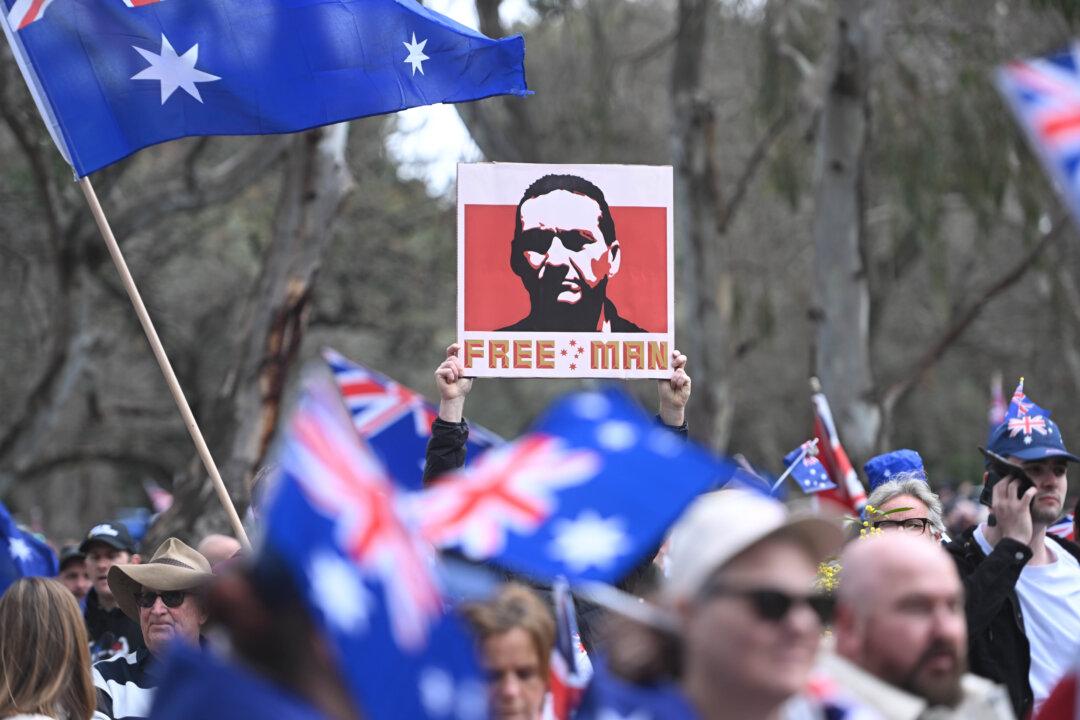 Man Arrested Over ‘Offensive’ Placard at Immigration Rally
