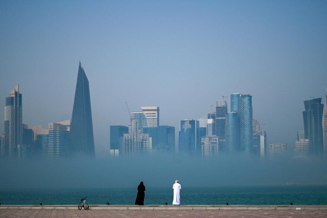 People look at the skyline covered in fog in Doha on February 9, 2026. (Photo by Mahmud HAMS / AFP via Getty Images)