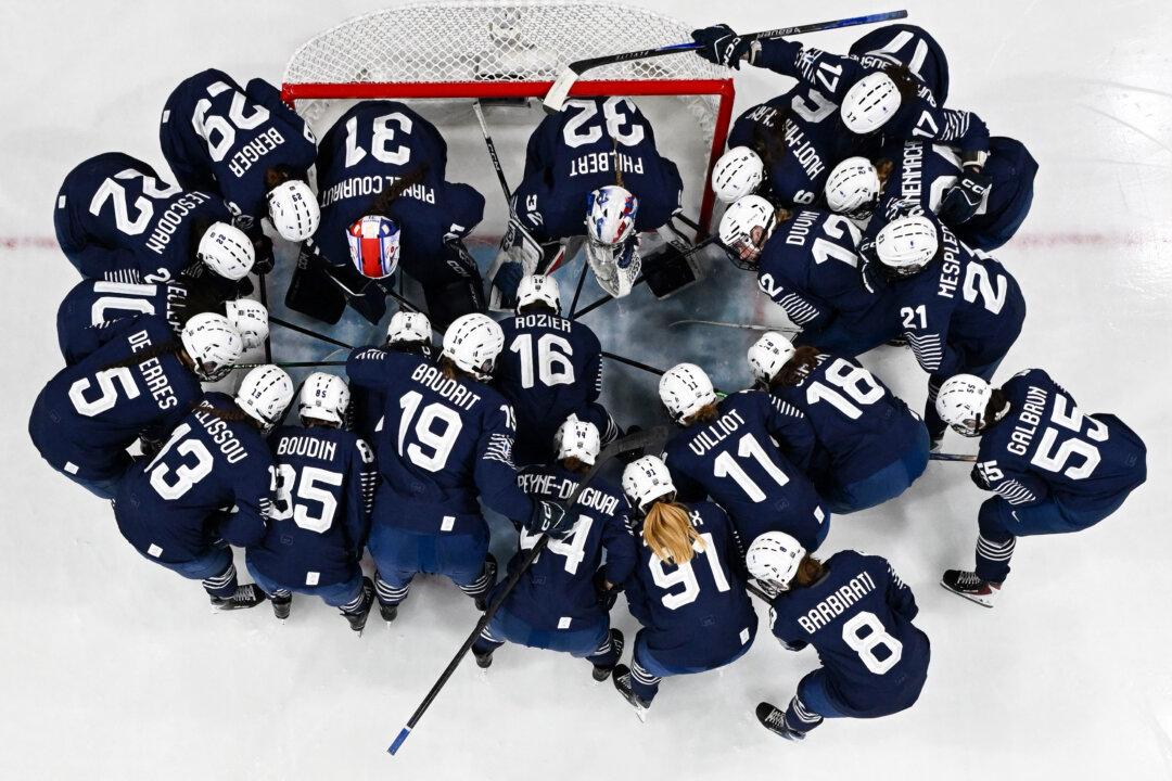 France's players gather prior to the women's preliminary round Group B Ice Hockey match between Germany and France at the Milano Rho Ice Hockey Arena at the Milano Cortina 2026 Winter Olympic Games in Milan, on February 9, 2026. (Photo by Alexander NEMENOV / AFP via Getty Images)