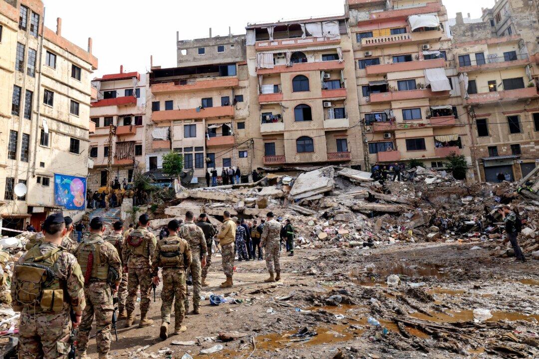 Lebanese soldiers secure the site on February 9, 2026, where an old residential building collapsed in the Bab al-Tabbaneh neighborhood of Tripoli a day earlier. The death toll in a building collapse in the northern Lebanese city of Tripoli rose to 14 after search and rescue operations ended, the civil defence chief said on February 9. (Photo by Anwar AMRO / AFP via Getty Images)