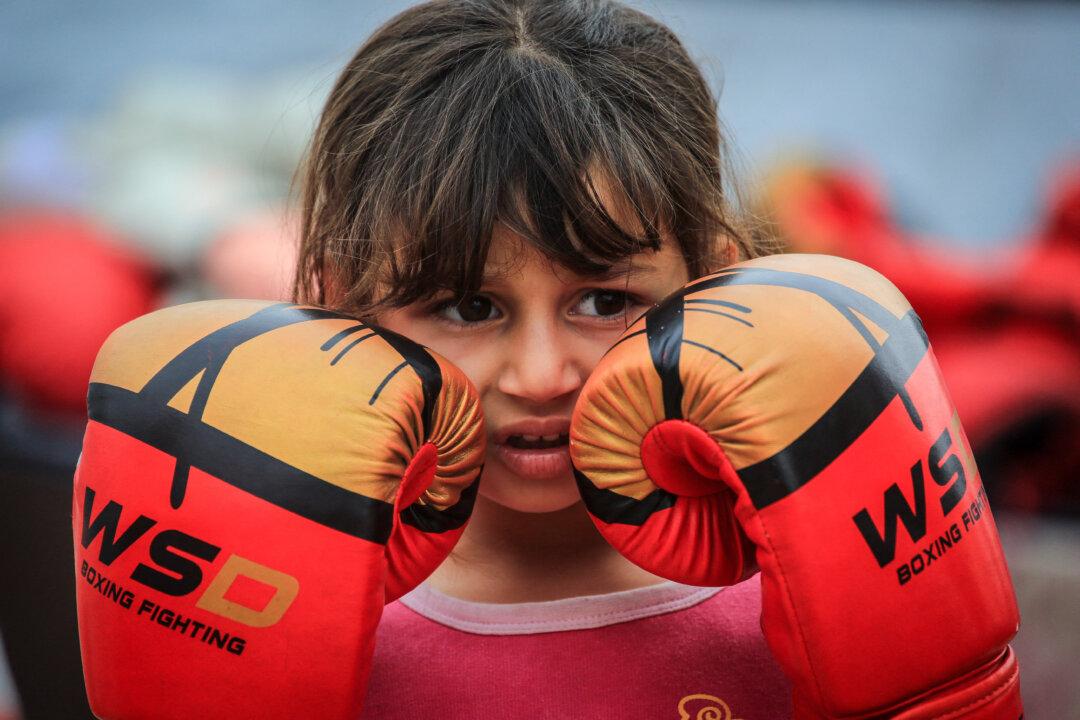 A young Palestinian girl holds her boxing gloves up to her face during a training session between displacement tents in Khan Yunis, in the southern Gaza Strip, on February 9, 2026. After a long hiatus from training, the women's boxing team - which consists of 45 boxers between the ages of 8 and 19 - has resumed its sessions under the guidance of their coach Osama Ayoub.
A US-brokered ceasefire, which sought to halt the fighting between Israel and Hamas sparked by the group's October 2023 attack, took effect last October, reducing the level of bombing and fighting. (Photo by BASHAR TALEB / AFP via Getty Images)