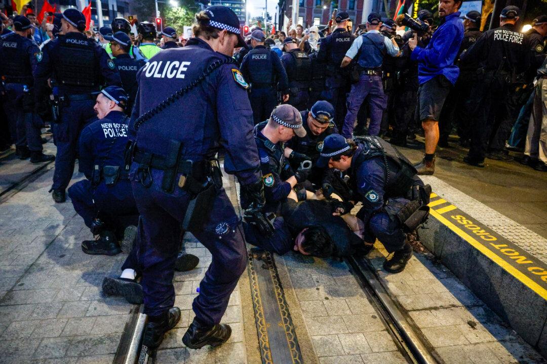 SYDNEY, AUSTRALIA - FEBRUARY 09: Police detain protesters during a protest against the visit of Israel's President Isaac Herzog on February 09, 2026 in Sydney, Australia. Herzog is on a visit to Australia from Feb 8-12 that will take in official engagements as well as meetings with the Jewish community. (Photo by Izhar Khan/Getty Images)