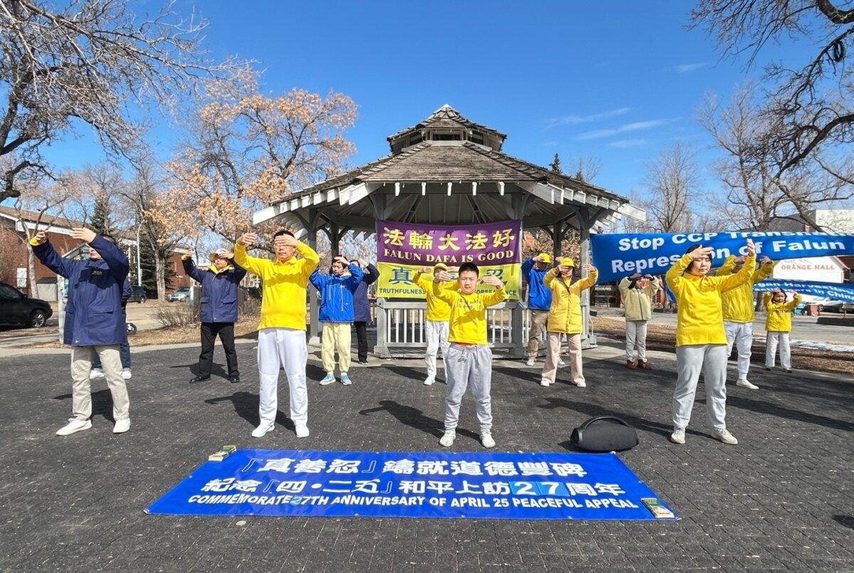 Falun Gong practitioners perform one of the meditative exercises of their spiritual practice at an event at Dr. Wilbert McIntyre Park in Edmonton on April 17, 2026, to commemorate the 27th anniversary of their fellow practitioners’ April 25, 1999, appeal in Beijing calling for freedom of belief. (The Epoch Times)