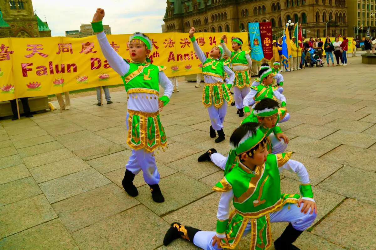 Young Falun Dafa practitioners participate in a dance performance as part of activities to celebrate World Falun Dafa Day on Parliament Hill in Ottawa on May 5, 2026. (Evan Ning/The Epoch Times)
