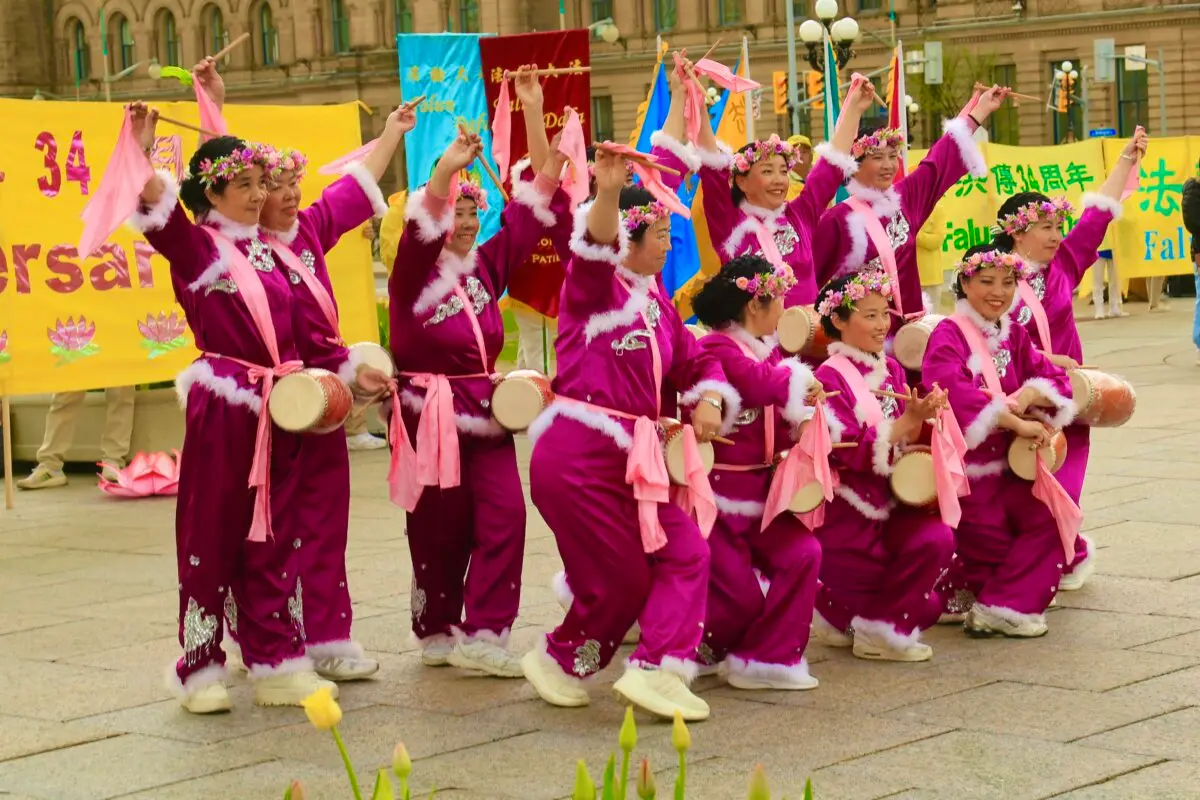 Falun Dafa practitioners perform a waist drum dance as part of activities to celebrate World Falun Dafa Day on Parliament Hill in Ottawa on May 5, 2026. (Evan Ning/The Epoch Times)