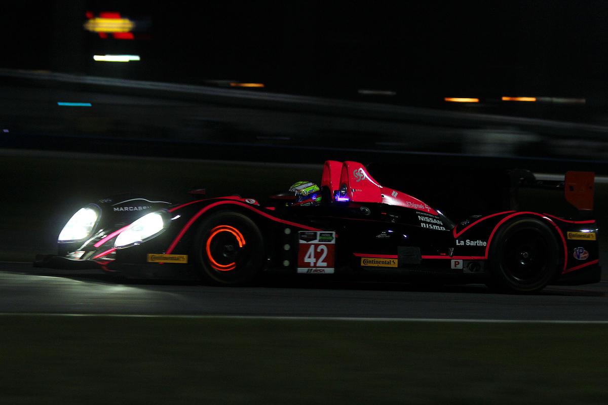 Red-hot brake rotors—one of the highlights of watching sports car racing at night. Here the #42 P2 Oak Morgan-Nissan approaches Daytona’s West Horseshoe. (Chris Jasurek/Epoch Times)