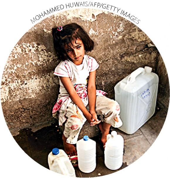 A girl rests after getting water from public taps in Sanaa, Yemen, on June 20, 2011. A study by Sanaa University reports that 70 to 80 percent of conflicts in rural areas are related to water.