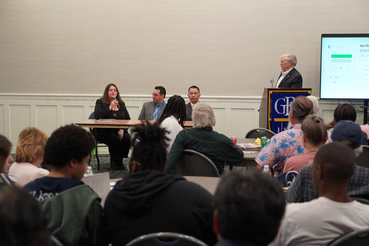 Delaware talk show host Rick Jensen, right, moderates a panel discussion at the Event Center of Goldey-Beacom College (GBC) in Delaware, on April 10, 2024. (Jennifer Yang /The Epoch Times)