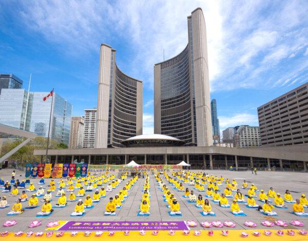Falun Gong adherents demonstrate their practice's exercises outside Toronto City Hall on May 11, 2024, celebrating the 32nd World Falun Dafa Day . (Alex Gurevich/The Epoch Times)