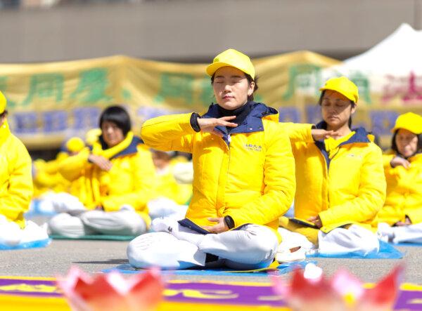 Falun Gong adherents demonstrate their practice's exercises outside Toronto City Hall on May 11, 2024, celebrating the 32nd World Falun Dafa Day . (Alex Gurevich/The Epoch Times)