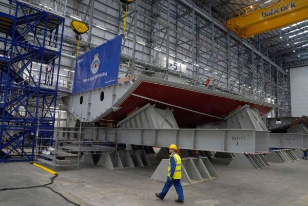 A worker passing a keel during a keel laying ceremony for the first Type 31 frigate at Babcock Rosyth in Rosyth, Scotland on April 26, 2022. (PA Wire)