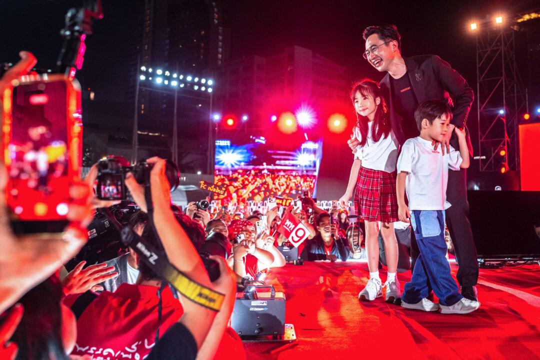 Pheu Thai Party's prime ministerial candidate Yodchanan Wongsawat poses with his son and daughter during a campaign rally ahead of the general election at Thephasadin Stadium in Bangkok on February 6, 2026. (Photo by chanakarn laosarakham / AFP via Getty Images)