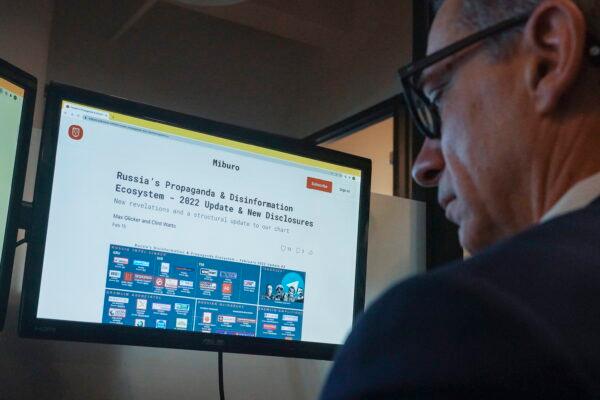 Clint Watts, president of Miburo, a research firm that tracks foreign disinformation operations, works at his desktop at company headquarters in New York on March 15, 2022. (Bebeto Matthews/AP Photo)