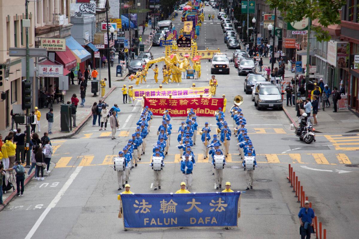 Falun Dafa practitioners march in a parade in San Francisco on May 6, 2023, to celebrate World Falun Dafa Day. (Lear Zhou/The Epoch Times)