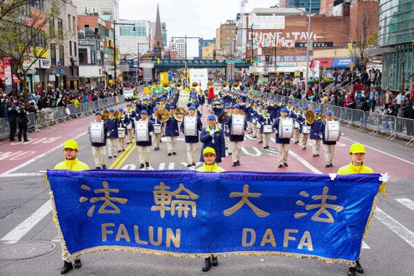 Falun Gong practitioners attend a parade to call for an end to the persecution in China of their faith, in the Flushing neighborhood of Queens, N.Y., on April 21, 2024. (Larry Dye/The Epoch Times)