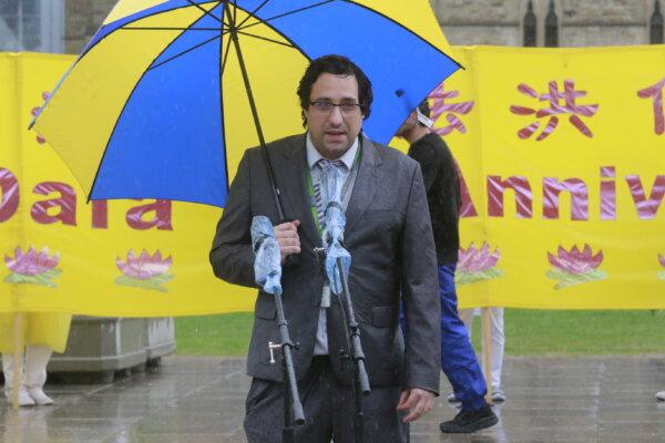 Philippe Refghi, assistant to Conservative MP and Quebec Lieutenant Pierre Paul-Hus, speaks on behalf of Mr. Paul-Hus during the Falun Dafa Day event on Parliament Hill in Ottawa on May 8, 2024. (Kano Ye/The Epoch Times)
