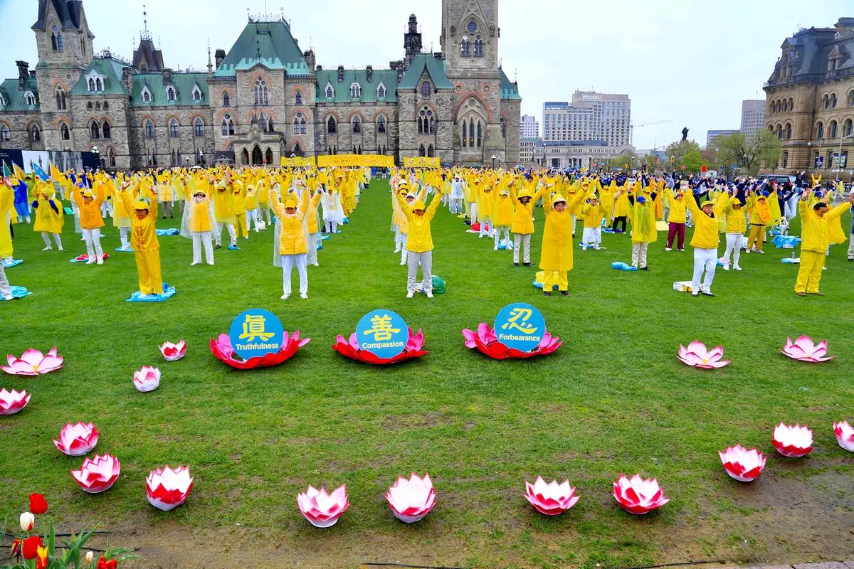 Falun Gong adherents demonstrate a meditative exercise during Falun Dafa Day celebrations on Parliament Hill in Ottawa, Canada, on May 8, 2024. (Jonathan Ren/The Epoch Times)