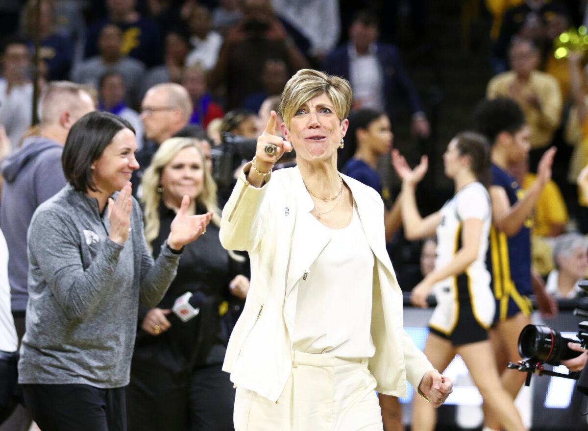 Associate head coach Jan Jensen of the Iowa Hawkeyes celebrates after the game against the West Virginia Mountaineers during their second-round matchup in the 2024 NCAA Division 1 Women Basketball Championship at Carver-Hawkeye Arena in Iowa City, Iowa on March 25, 2024. (Matthew Holst/Getty Images)