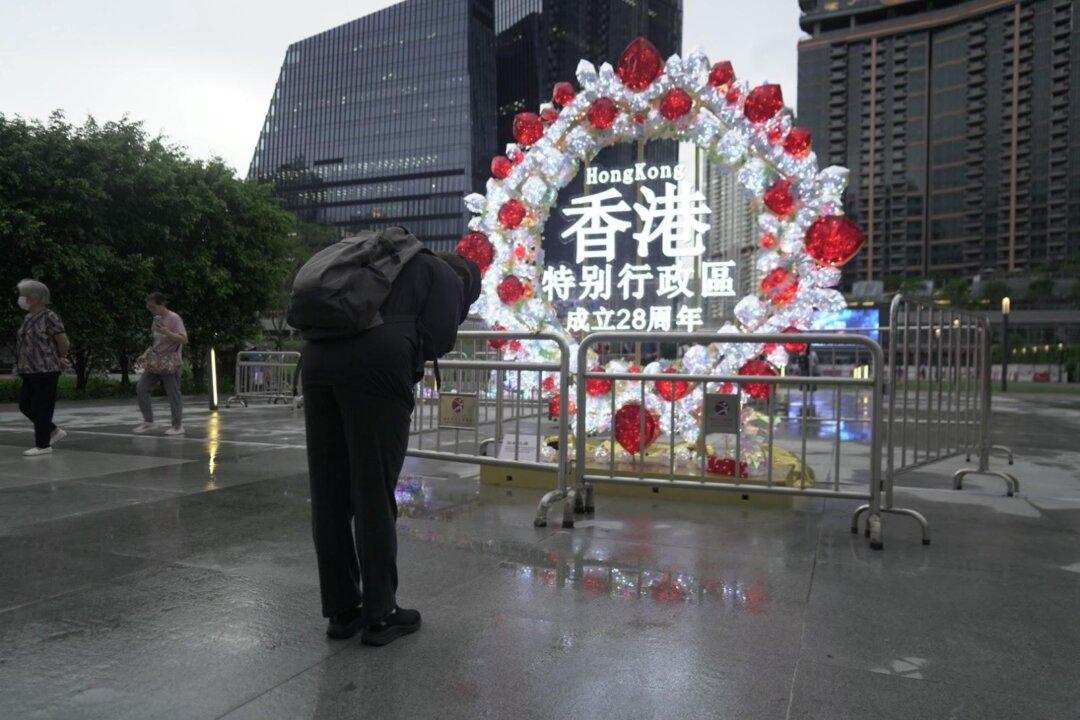 Hong Kong Locals Bow to Commemorative Plaque to Mourn 28-Year Anniversary of Transfer of Sovereignty