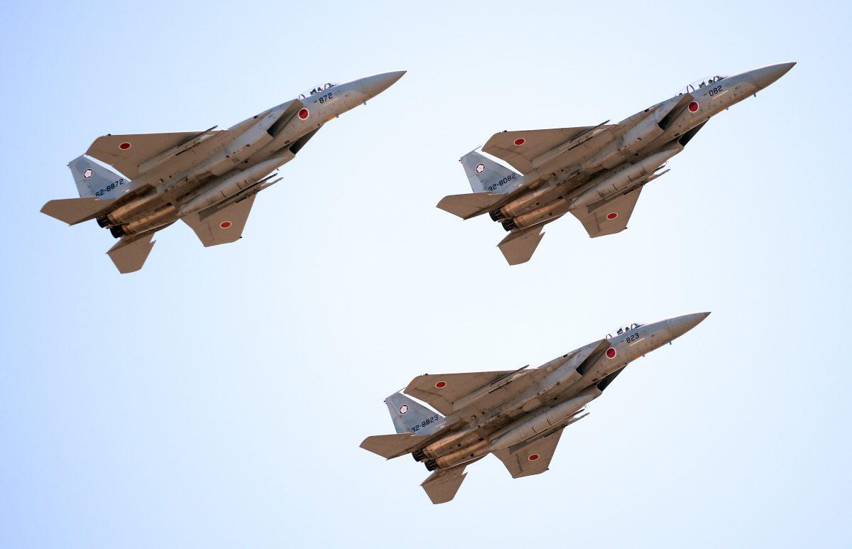 Japanese F-15 jets fly during the military review at the Ground Self-Defense Force's Asaka training ground on Oct. 27. (Toru Yamanaka/AFP/Getty Images)
