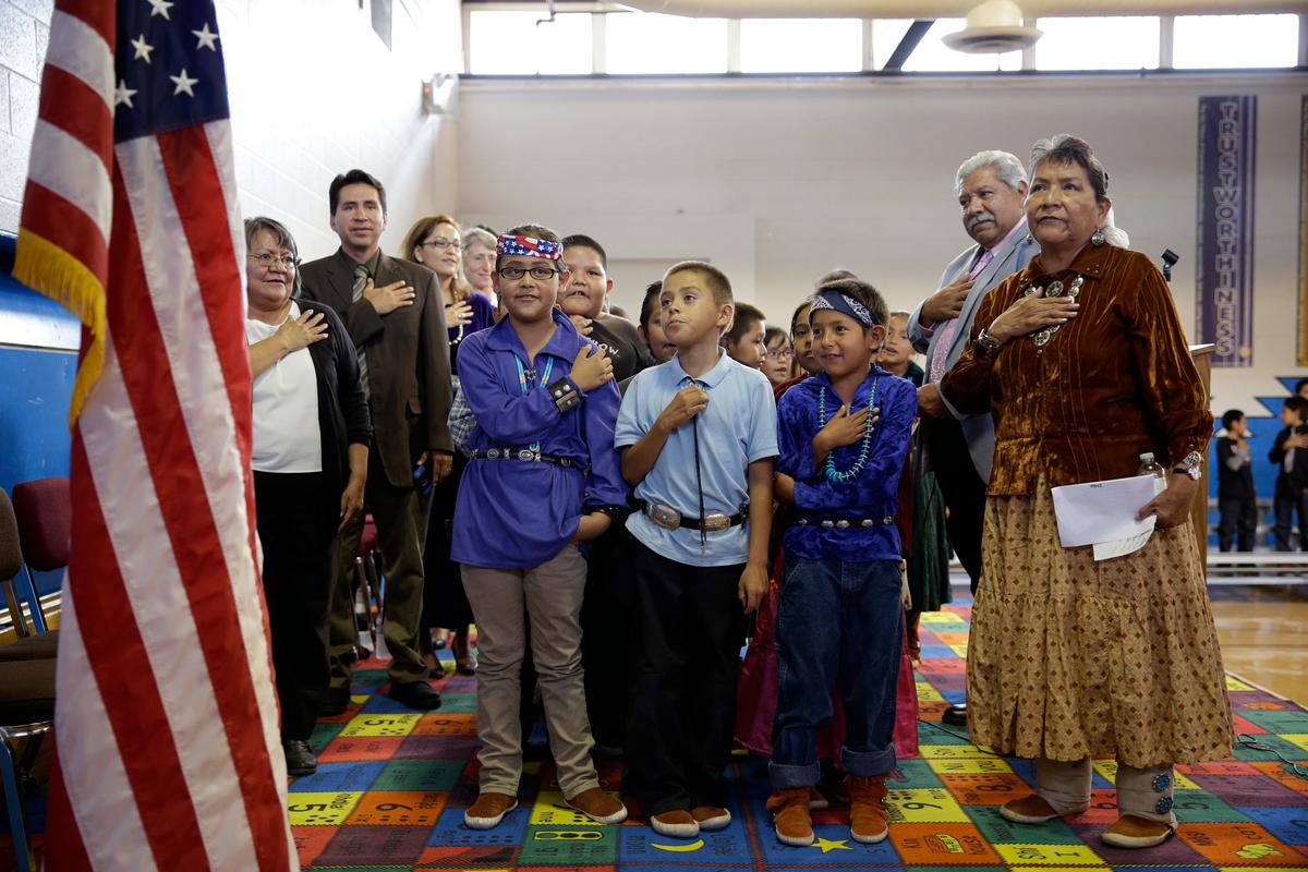 Students and faculty say the Pledge of Allegiance during an assembly at the Crystal Boarding School in Crystal, N.M., on the Navajo Nation, on Sept. 26, 2014. The school is one of 183 for Native American students run by the Interior Department's Bureau of Indian Education. (John Locher/AP Photo)