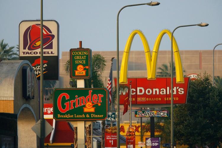 Signs for fast-food restaurants line the streets of the Figueroa Corridor in Los Angeles on July 24, 2008. (David McNew/Getty Images)