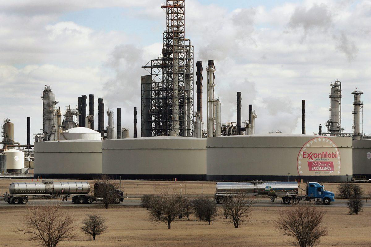 Tanker trucks drive past an oil refinery in Joliet, Ill., on March 8, 2005. (Scott Olson/Getty Images)