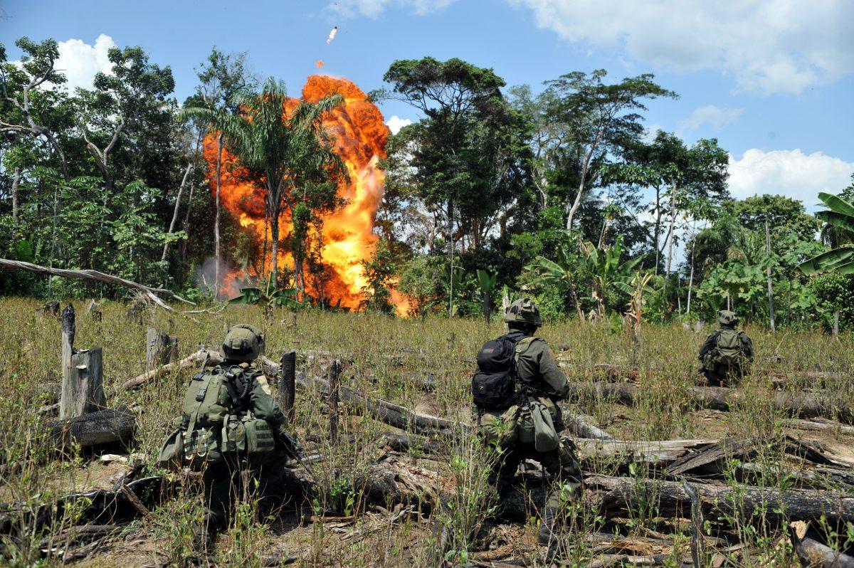 Anti-narcotics police officers blow up a laboratory for processing cocaine from the Revolutionary Armed Forces of Colombia (FARC) in Puerto Concordia Municipality, Colombia, on Jan. 25, 2011. (Guillermo Legaria/AFP/GettyImages)