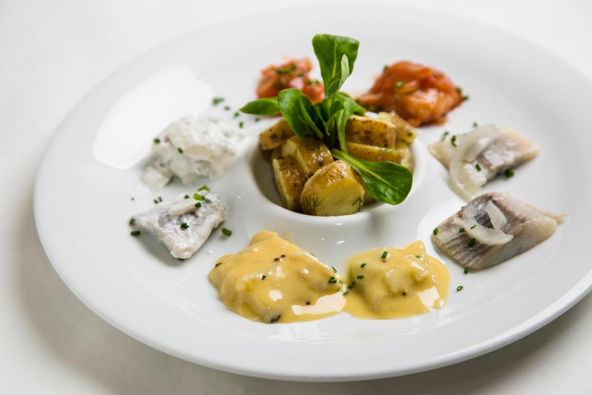The Herring Quartet at Smorgas Chef, done four ways: pickled, in mustard, in dill and cream, and in tomato sauce. (Samira Bouaou/Epoch Times)