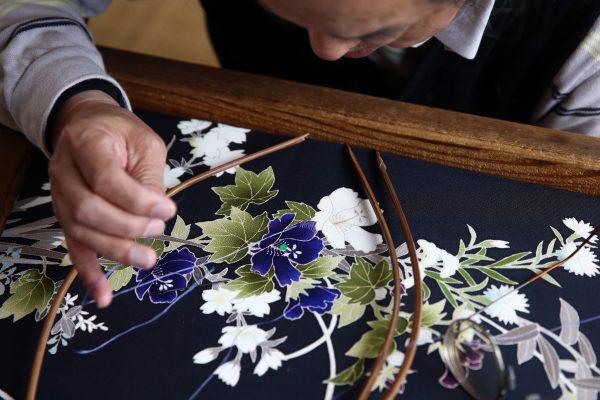 Stitching master Hitoshi Nakano works on a kimono at the Sensyo Ichikawa kimono workshop in Kyoto, Japan, on April 26, 2016. (Carl Court/Getty Images)