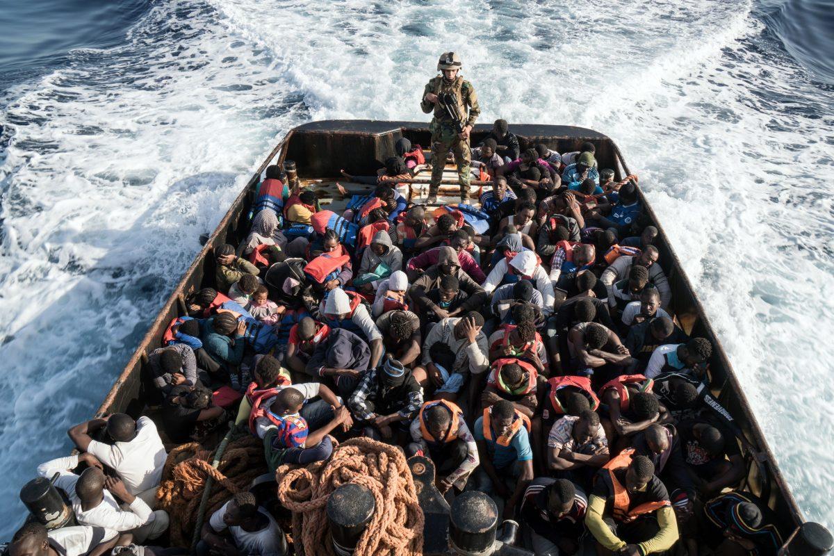 A member of the Libyan Coast Guard stands on a boat during the rescue of 147 illegal immigrants attempting to reach Europe off the coastal town of Zawiyah, west of the capital Tripoli, on June 27, 2017. (Taha Jawashi/AFP/Getty Images)