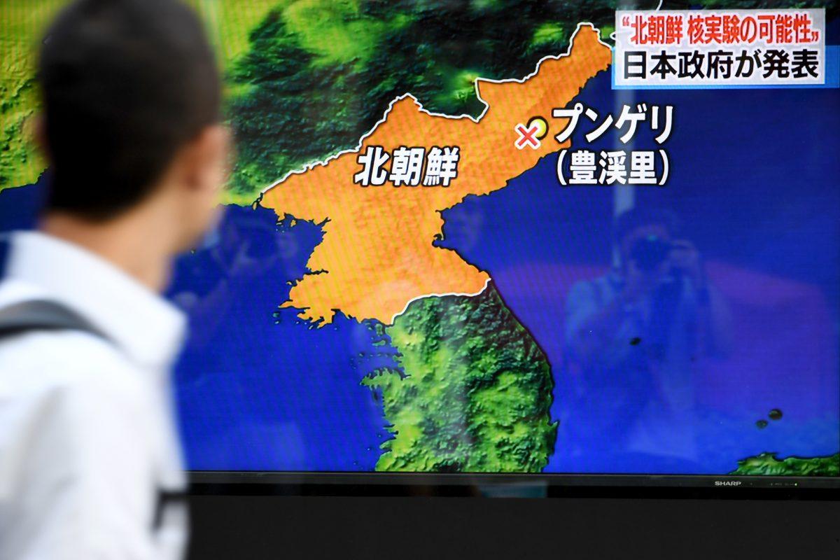 Pedestrians walk past a television screen broadcasting a news program on North Korea's nuclear test in Tokyo on Sept. 3, 2017. (Toshifumi Kitamura/AFP/Getty Images)