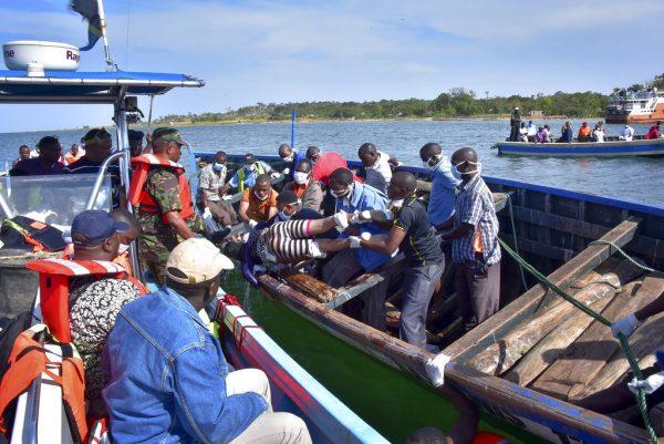 Rescuers retrieve a dead body from the water near Ukara Island in Lake Victoria, Tanzania, on Sept. 21, 2018. (AP Photo)