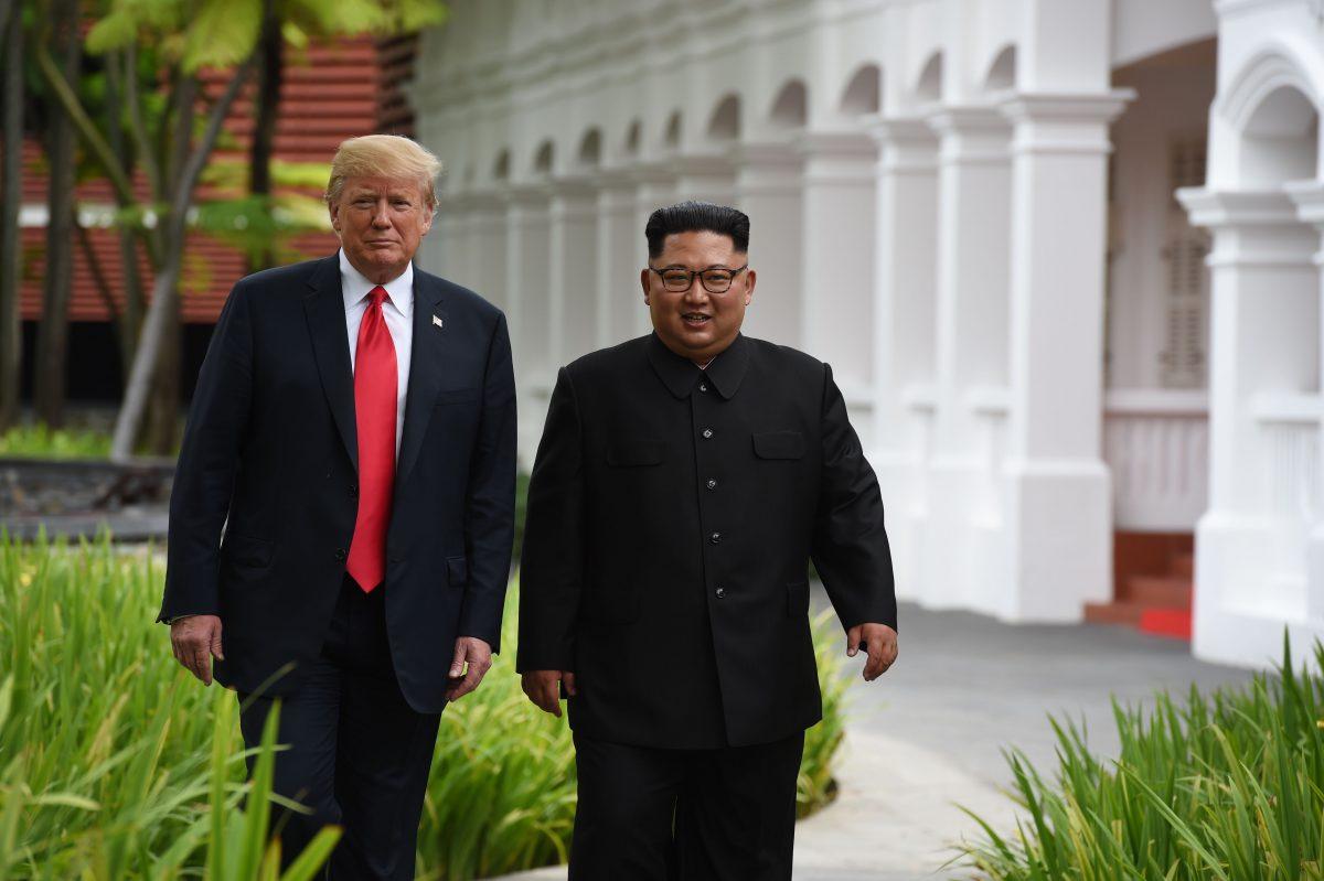 North Korean leader Kim Jong Un (R) walks with U.S. President Donald Trump (L) during a break in talks at their historic U.S.–North Korea summit at the Capella Hotel on the island of Sentosa, Singapore, on June 12, 2018. (Anthony Wallace/AFP)