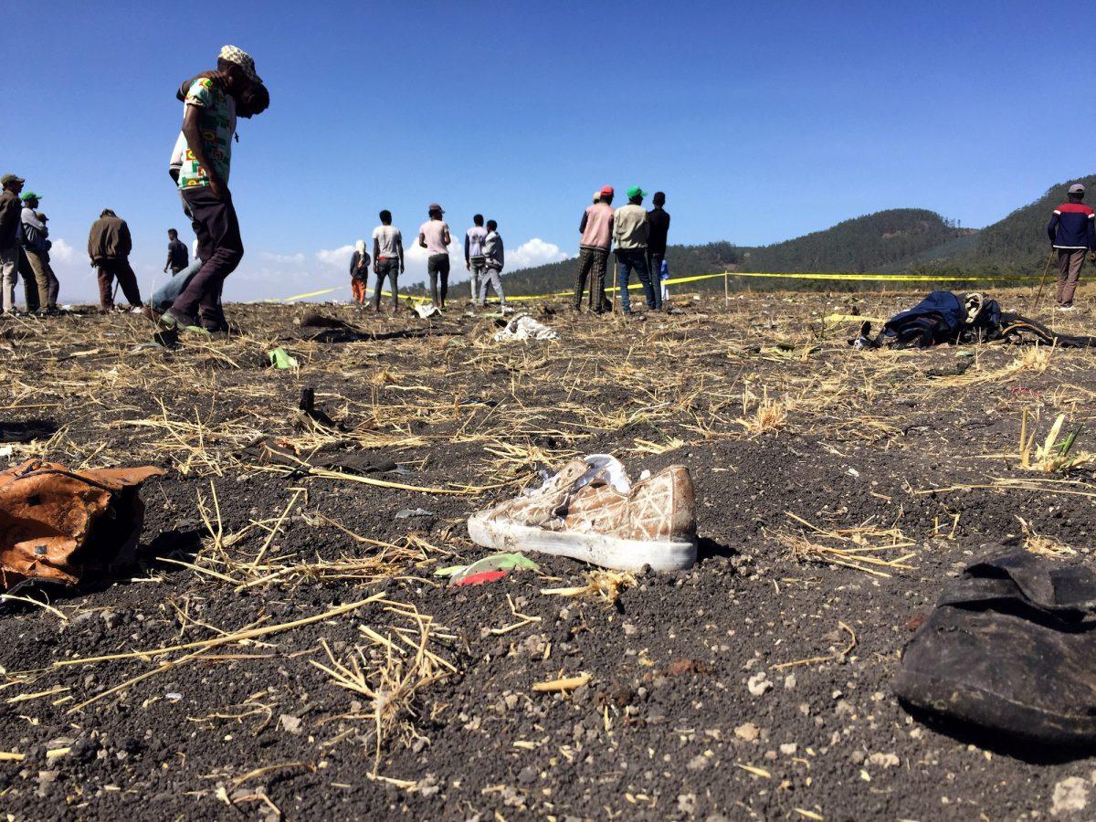 People walk past a part of the wreckage at the scene of the Ethiopian Airlines Flight ET 302 plane crash, near the town of Bishoftu, southeast of Addis Ababa, Ethiopia, on March 10, 2019. (Tiksa Negeri/Reuters)