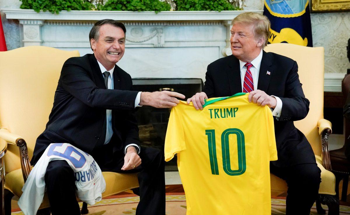 Brazilian President Jair Bolsonaro presents a Brazilian national soccer team jersey to U.S. President Donald Trump during a meeting in the Oval Office of the White House on March 19, 2019. (Kevin Lamarque /file/Reuters)