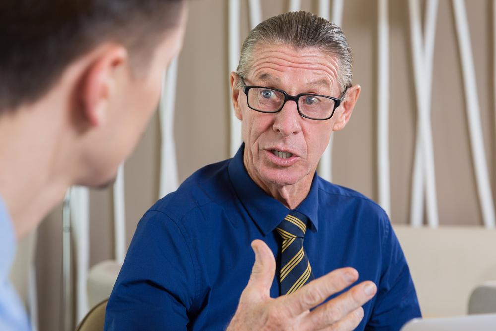 Illustration - Shutterstock | <a href="https://www.shutterstock.com/image-photo/astonished-senior-businessman-talking-young-man-507428974">Mangostar</a>
