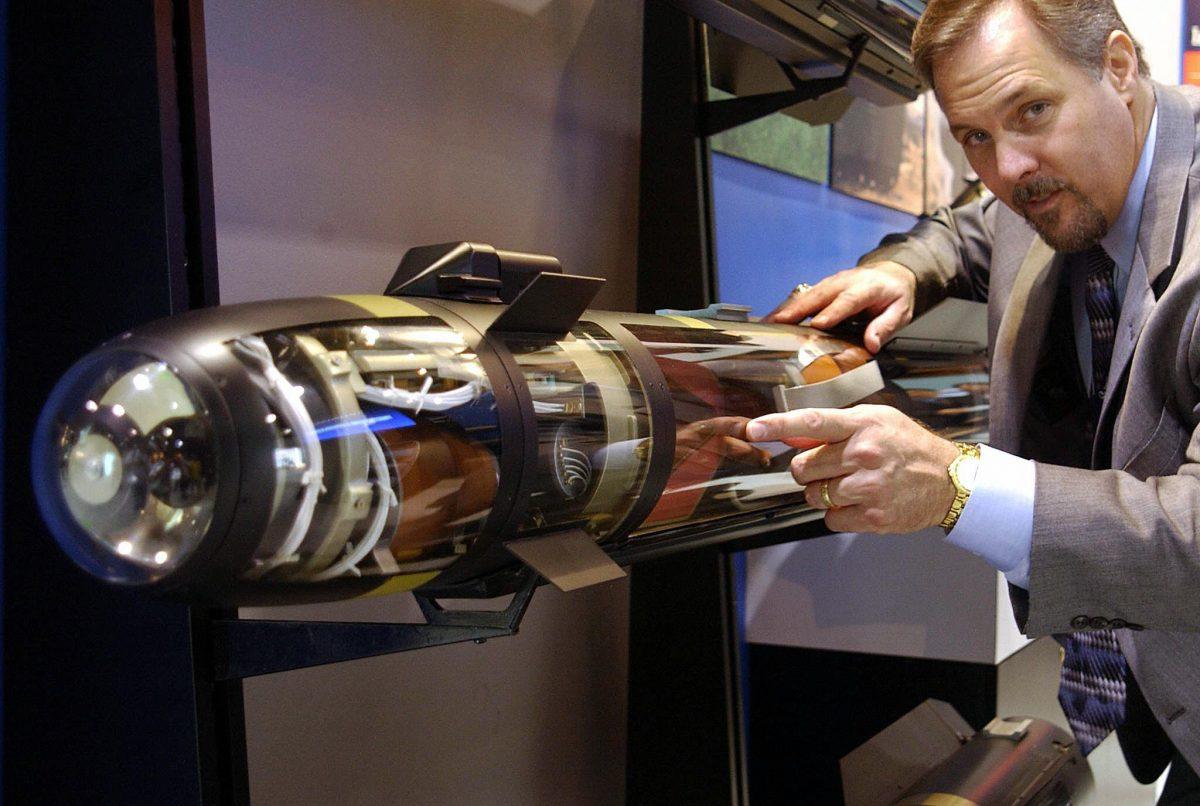David J. Huber, manager of International Business Development, points to a Hellfire II missile provided by U.S. manufacturer Lockheed Martin on 14 Aug. 2003. (Same Yeh/AFP/Getty Images)