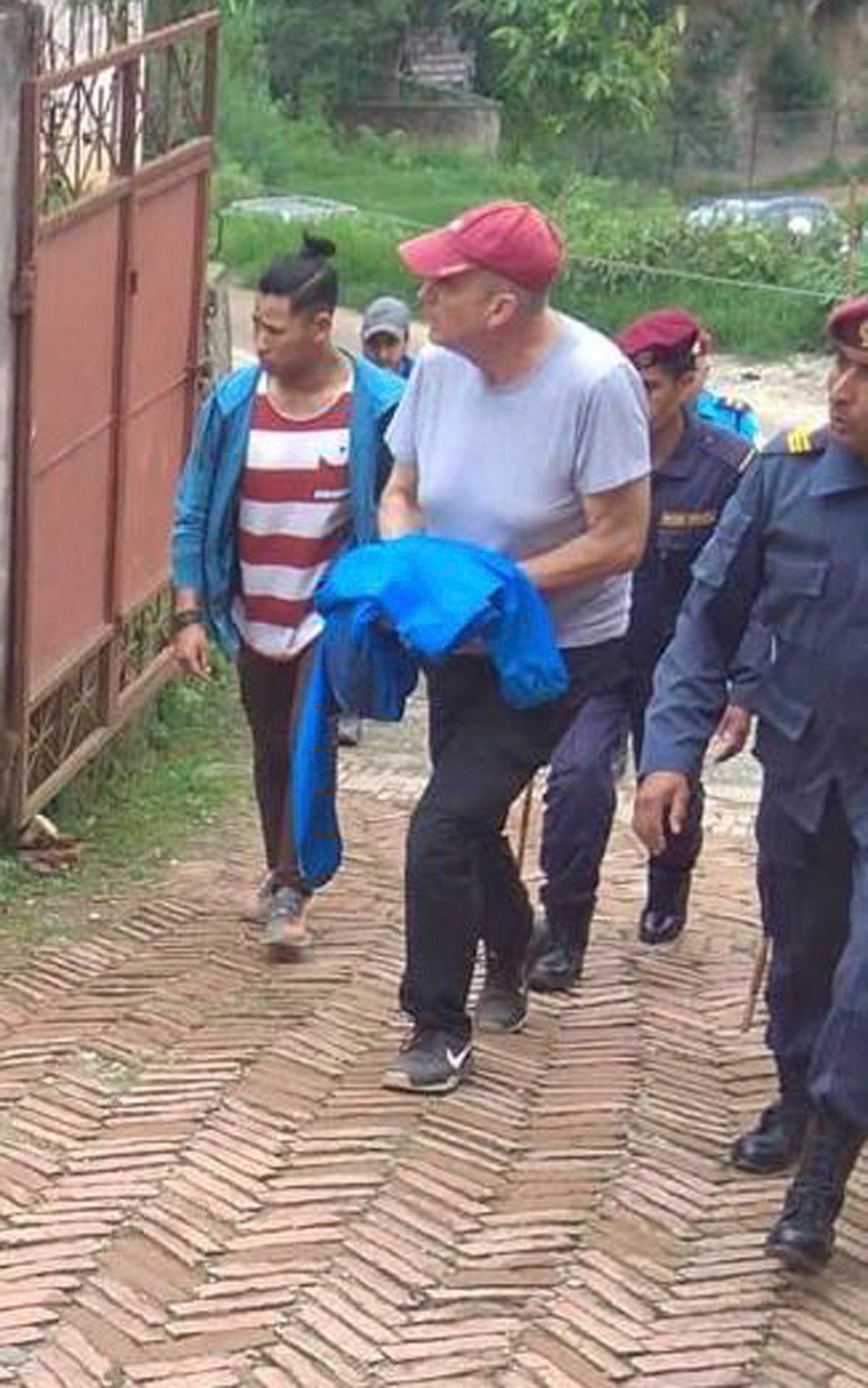 Canadian aid worker Peter Dalglish (C) is brought to appear before the Kavre District Court in Nepal. (AP Photo/ Janak Raj Sapkota)