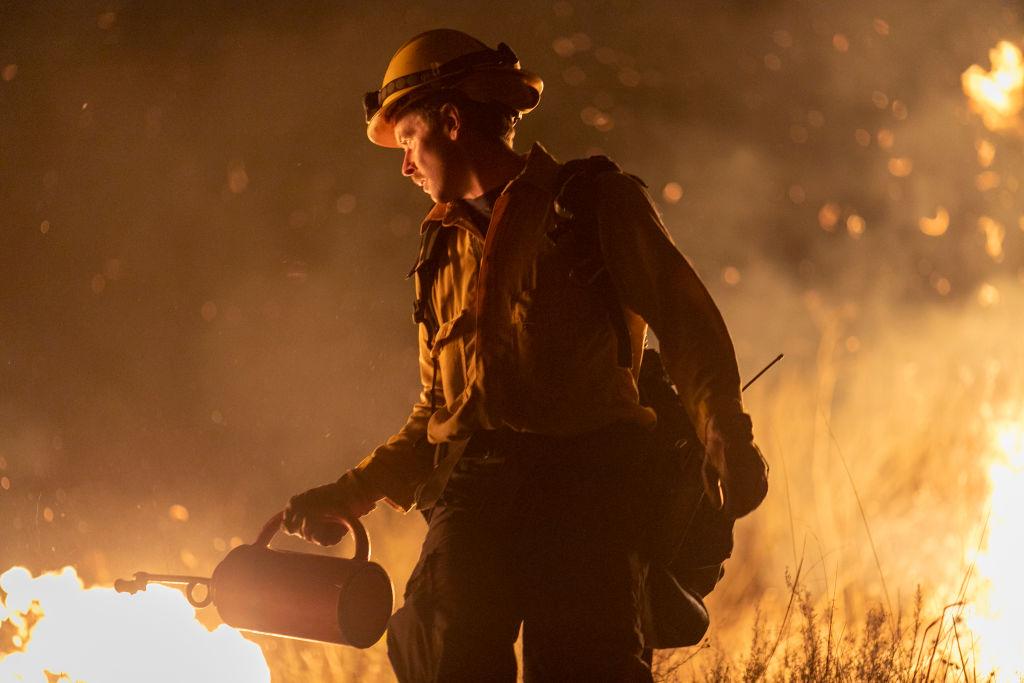 A firefighter uses a drip torch to start a backfire as the Maria Fire explodes to 8,000 acres on its first night near Somis, Calif., on Nov. 1, 2019. (David McNew/Getty Images)