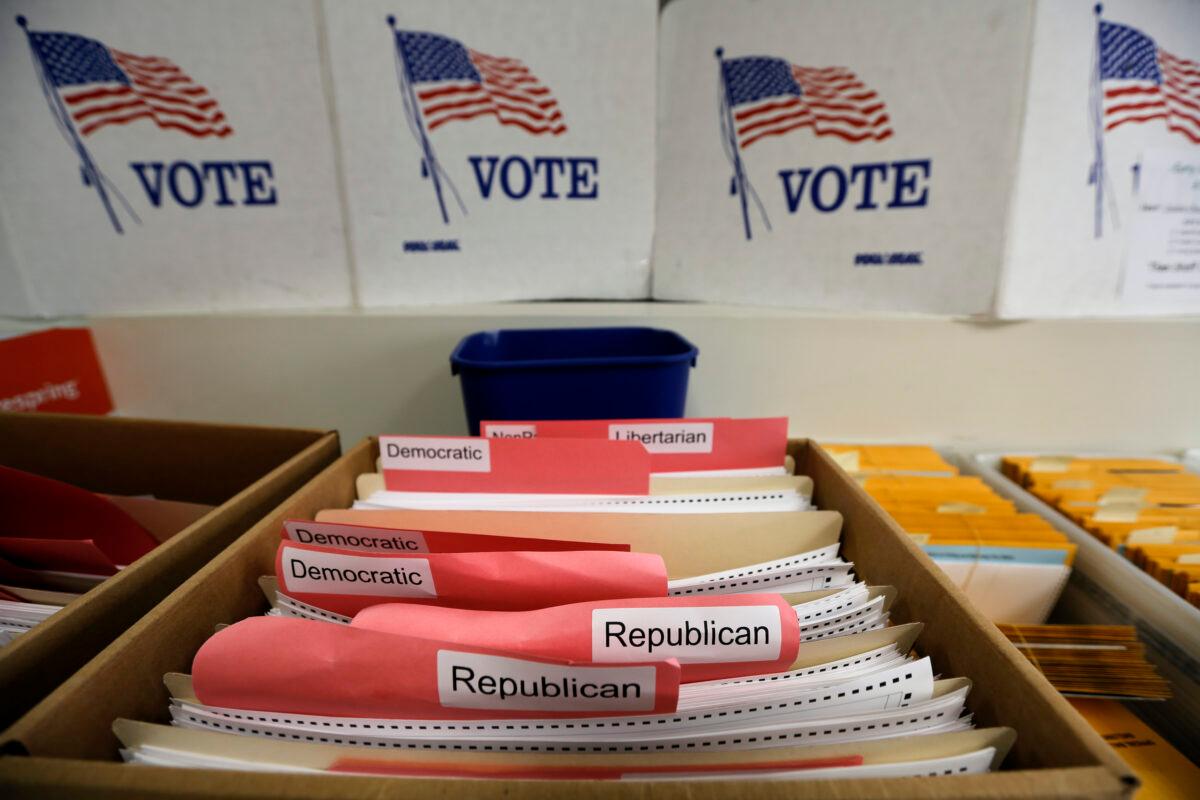 In this April 14, 2020, file photo, ballots for the primary elections are arranged by party affiliation at the Lancaster County Election Committee offices in Lincoln, Neb. (Nati Harnik/AP photo)